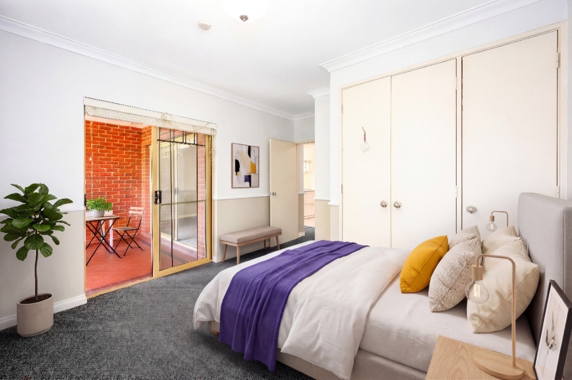 After photo of the same room virtually staged as a bedroom.